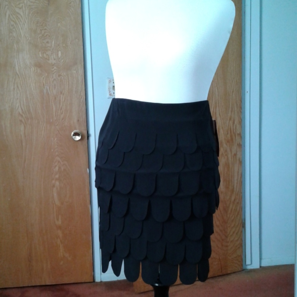 NWT. Pull-on black skirt with layers of U cuts